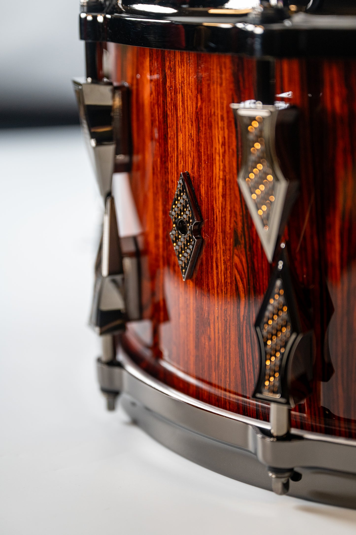 Cocobolo 10 Lug Stave Snare Drum 7.5''x14'' High Gloss Finish with Black Chrome Lugs and Copper Lightning Strike Carbon Fiber Inlays
