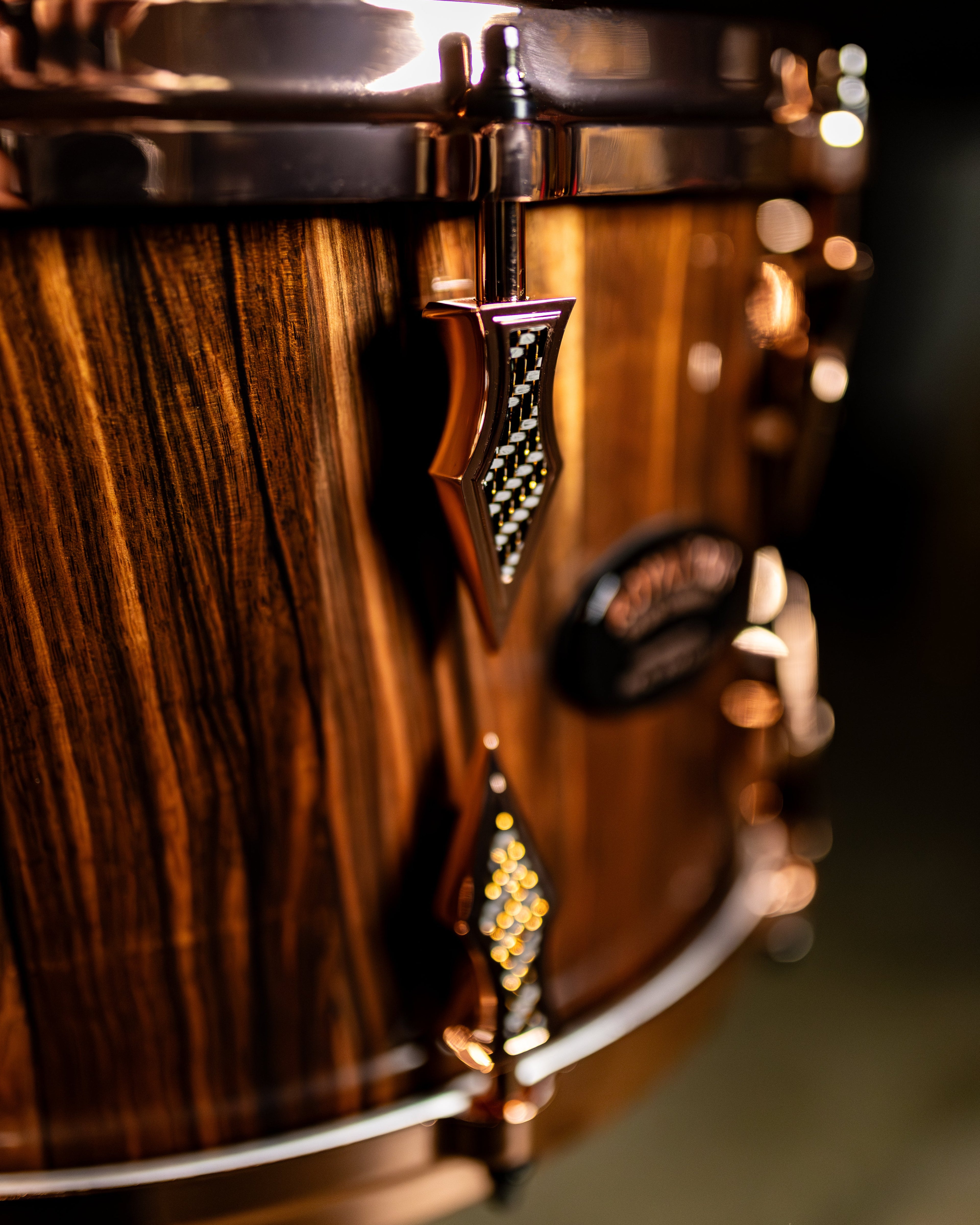 Close-up of a wooden drum with decorative elements on a blurred background